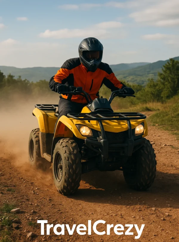 “Person riding a yellow ATV quad bike on a dusty off-road trail wearing helmet and gear”