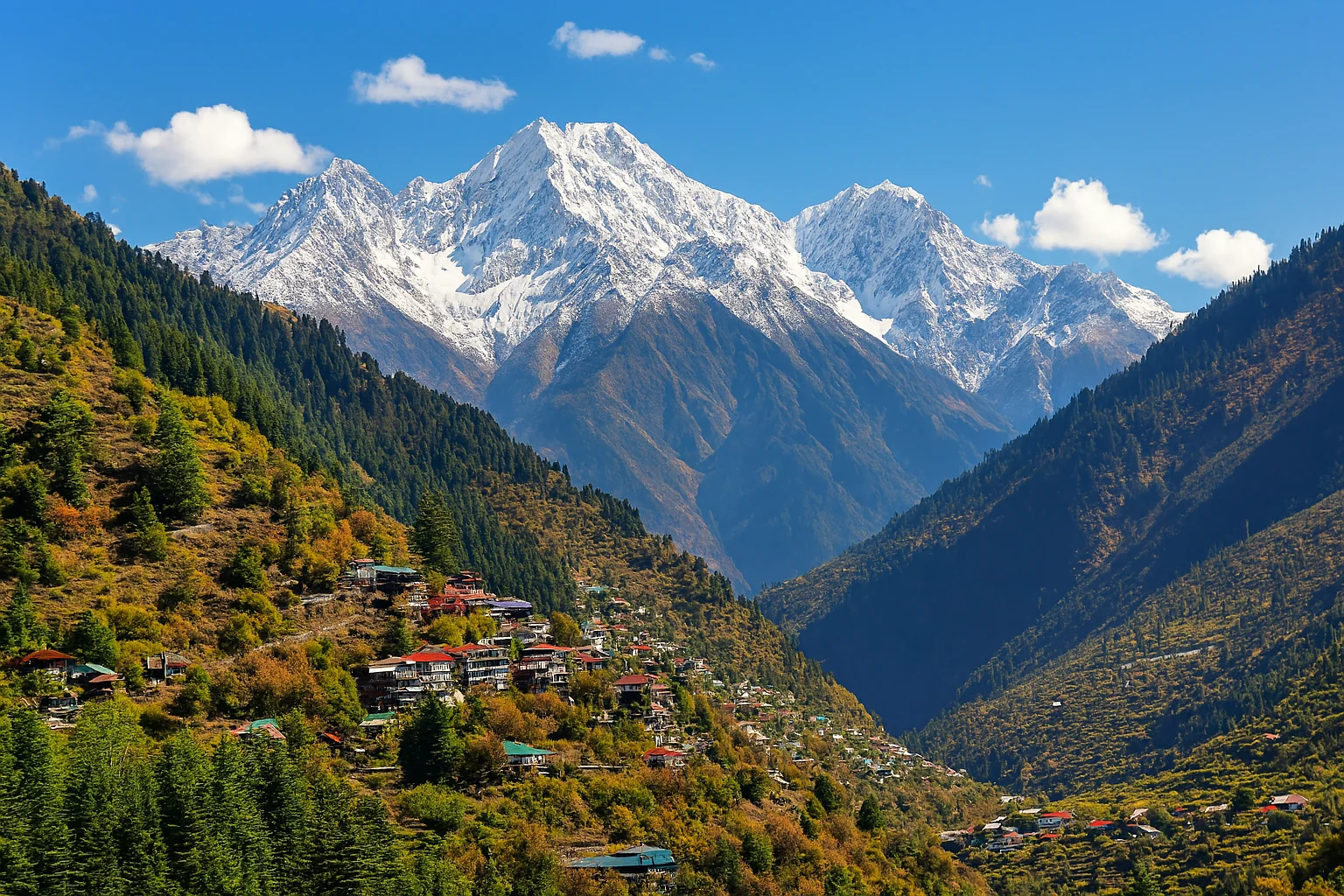 “Snow-covered Himalayan mountain peaks with a scenic valley and colorful hillside village in Himachal Pradesh”